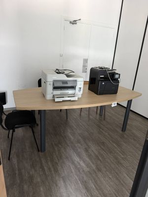a desk with a printer and a printer on it
