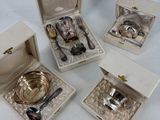 four pieces of silverware sitting in a box on a white surface