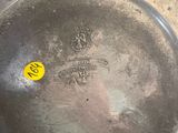 a metal pan with a yellow sticker on it