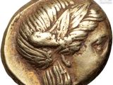 a gold coin with a bird on it ' s head