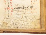 an old book with writing on it on a table