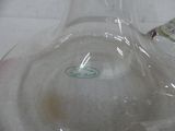 a clear glass vase with a green sticker on it