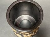 a metal cup that has a hole in the middle of it
