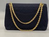 a black quilted purse with gold chain straps