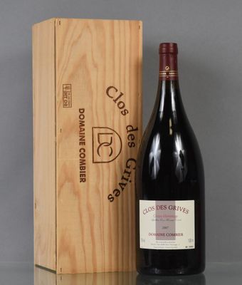 a bottle of wine sitting next to a wooden box on a table