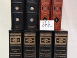 several books are stacked on top of each other on a white surface