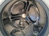 a close up of a washing machine with the door open