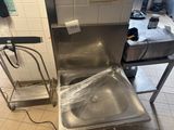 a sink in the middle of a kitchen that is being cleaned