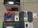 a box with a keyboard, mouse, mouse pad, and other items on the floor