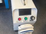 a machine that is sitting on the floor next to a chair