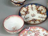 several different types of plates and bowls are arranged on a table