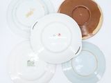several plates are stacked on top of each other on a white surface