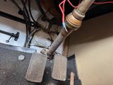 two pedals that are on the floor of a room