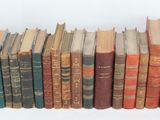 a lot of books that are stacked on top of each other