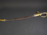 a close up of a knife on a table with a black background