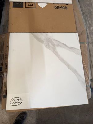 a cardboard box that is sitting on the floor next to a pair of shoes