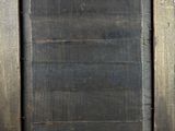 an old picture frame with a black background and a brown border