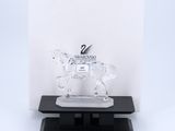 a clear horse figurine on a black base with a white background