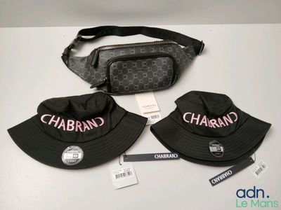 two hats and a fanny bag are sitting on a table