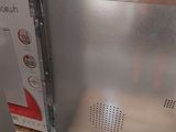 a silver refrigerator that is sitting on a pallet