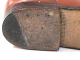 a close up of a pair of shoes with holes in the sole