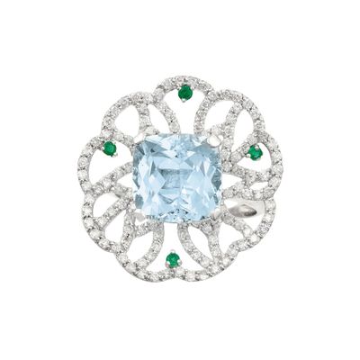 a close up of a ring with a blue topaz and emerald stones