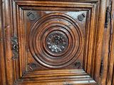 an old wooden cabinet with a carved design on the door