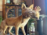 a statue of a dog with a bird in it ' s mouth