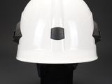 a close up of a white hard hat on a black background
