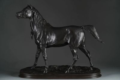 statue of a black horse on a wooden base on a gray background