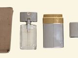 a bottle of perfume and a case on a table