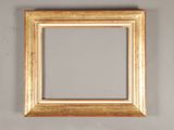 gold frame on a gray wall with a white wall in the background
