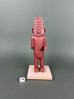 an image of a wooden statue of a man with a hat on his head