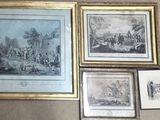 many framed pictures on the wall of a living room