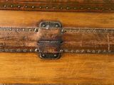 a wooden trunk with a metal latch on top of it