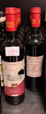 bottles of wine are lined up on a shelf in a store