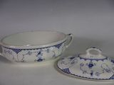 a blue and white bowl and saucer on a white table