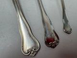 three spoons and a fork are sitting on a table