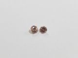 a pair of brown diamonds on a white surface
