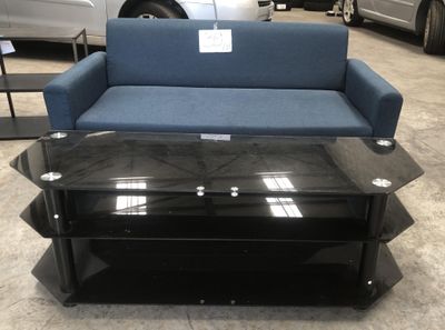 un canapé bleu et une table basse noire dans un showroom