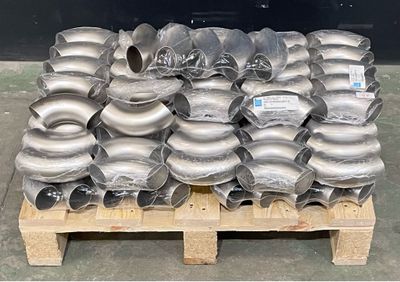 a pallet with many different types of pipes and fittings