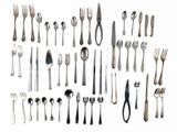 a lot of forks and spoons on a white surface