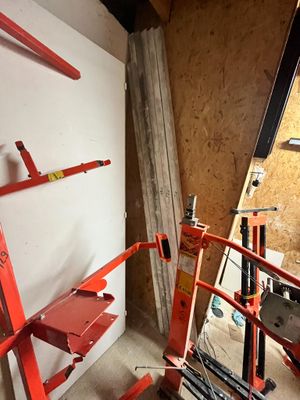 une photo d'une pièce avec une échelle et des outils accrochés au mur