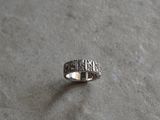 a silver ring that is sitting on a table
