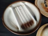 three plates with a fork and a plate with a spoon on it
