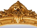 a mirror with a gold frame on a white background