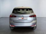 the rear end of a silver bmw v - cross parked in a white room