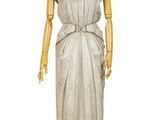 mannequin dressed in a white dress on a wooden stand