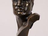 a bronze bust of a man on a marble base