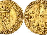 a gold coin with a cross on the front and a crown on the back